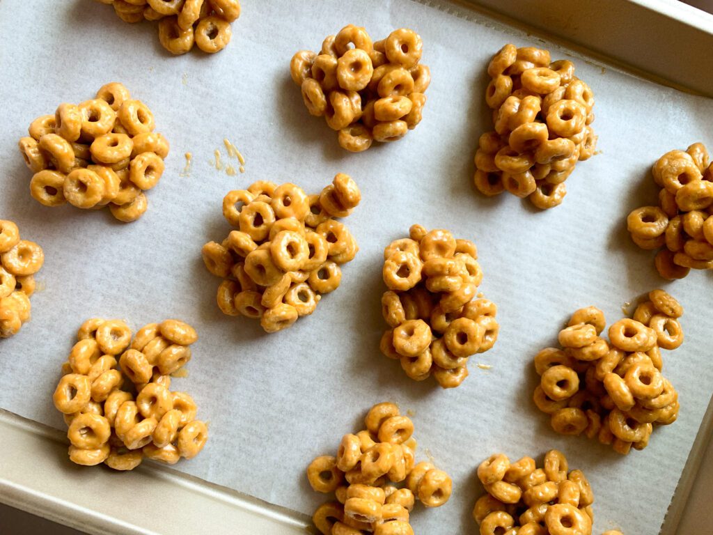 peanut butter cereal bites on parchment lined baking sheet