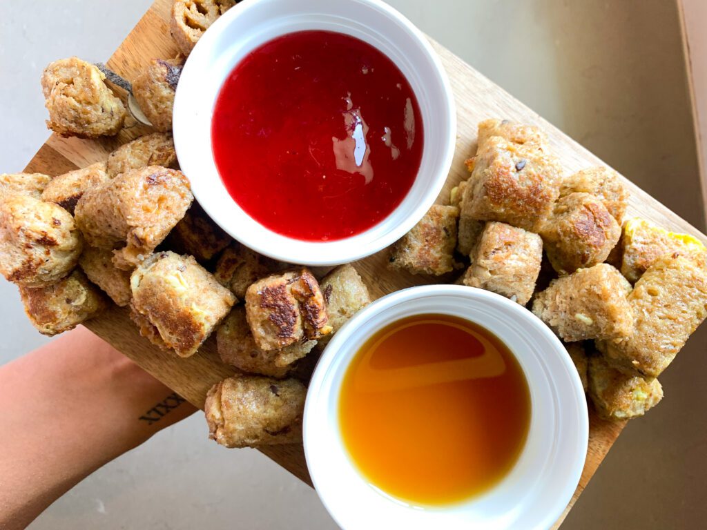 peanut butter french toast roll ups plated with maple syrup and jelly